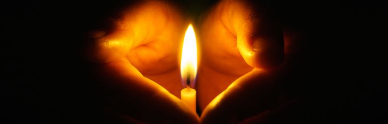 Hands holding candle
